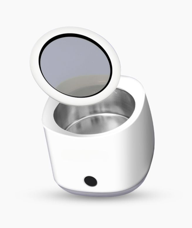 Chomper Labs ultasonic cleaner for night guards with lid floating above.