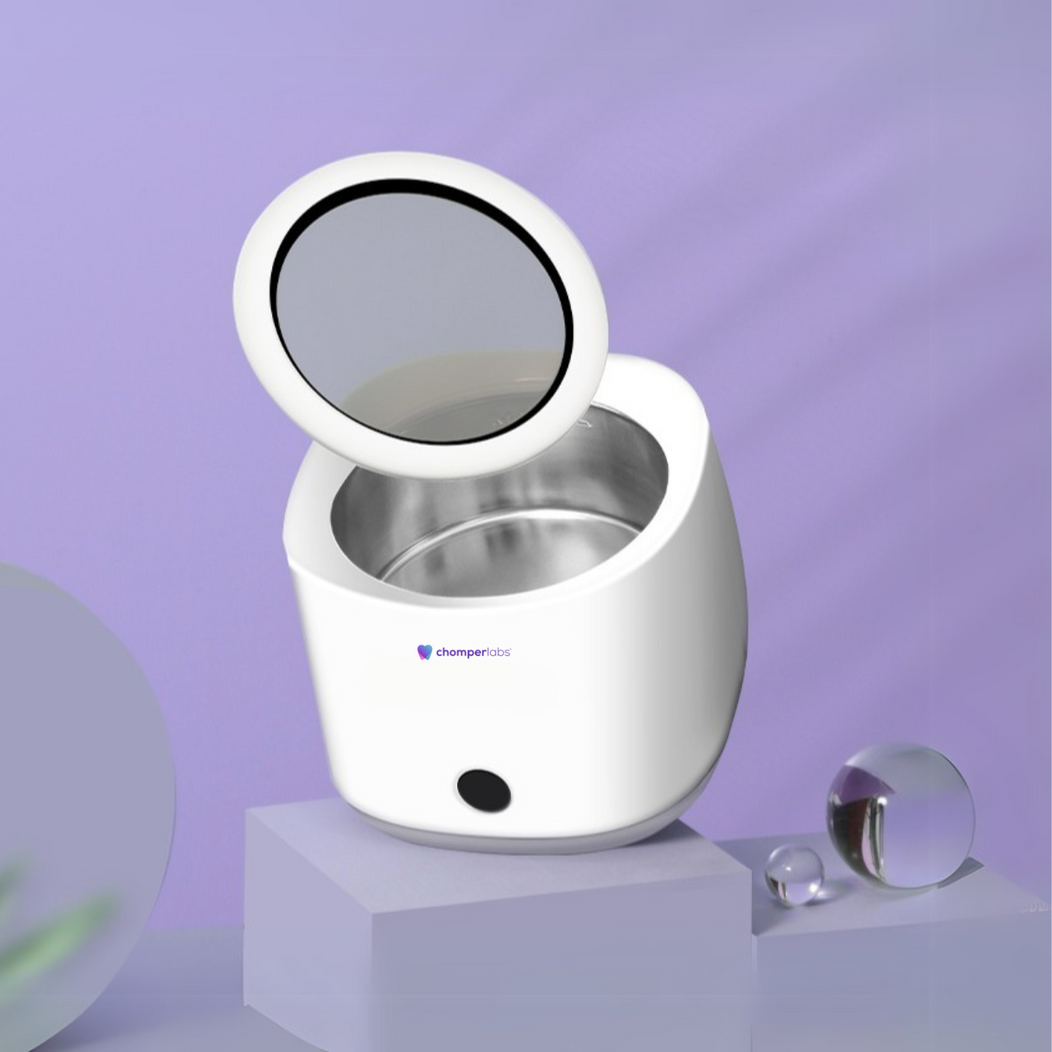 Chomper Labs ultrasonic cleaner for night guards pictured on a pedestal.